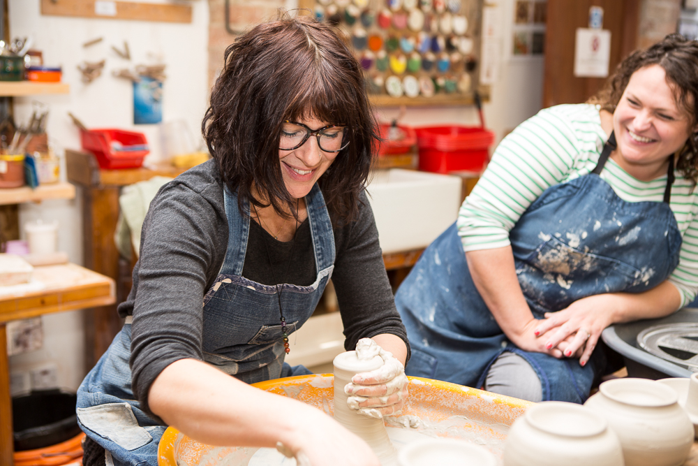 Leyla demonstrating throwing to students at The Ceramics Studio